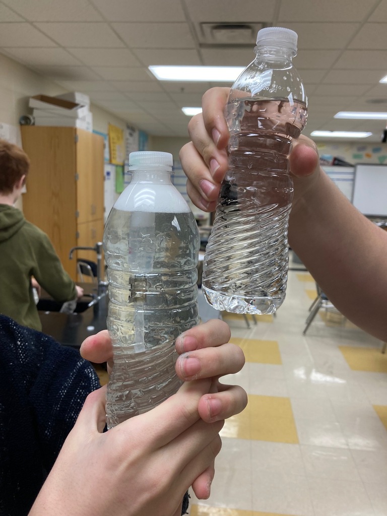 Students squeezing the bottle making the "Diver" drop to the bottom