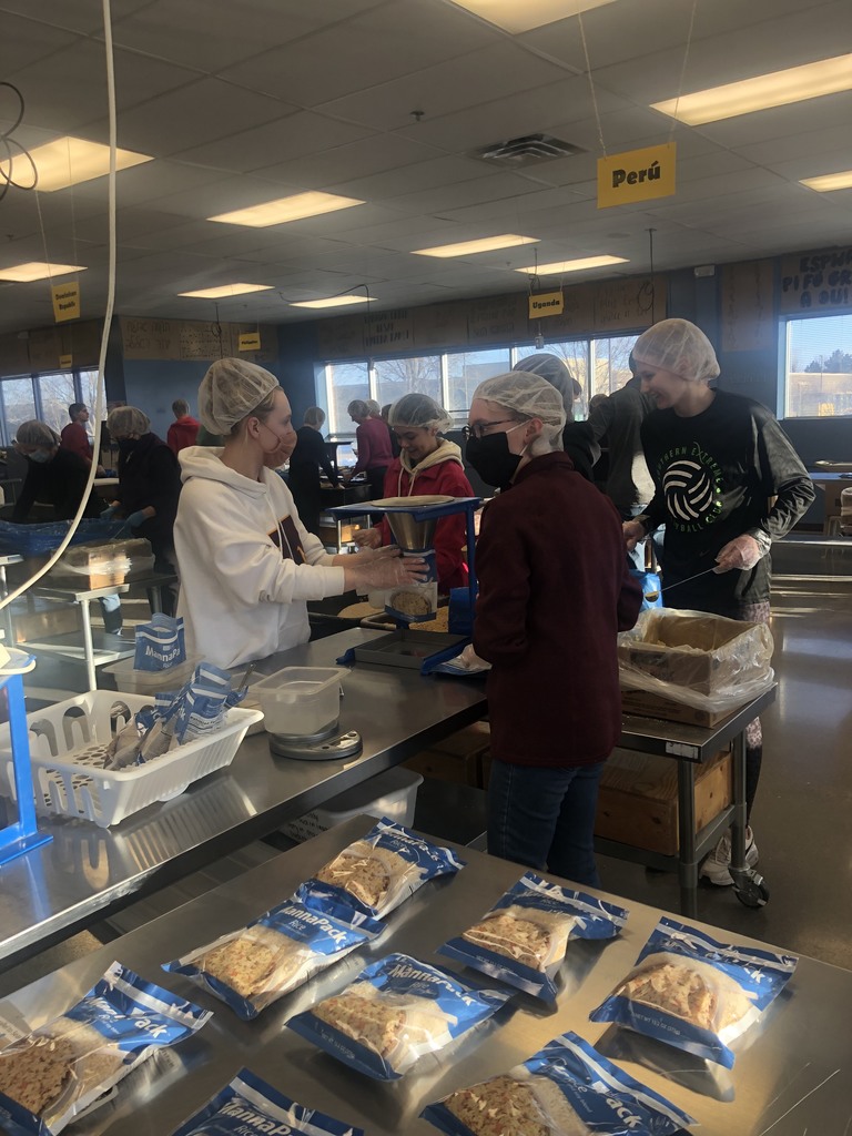 Students working to pack meals