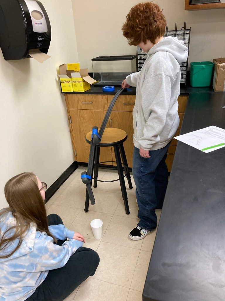 Students making a marble track