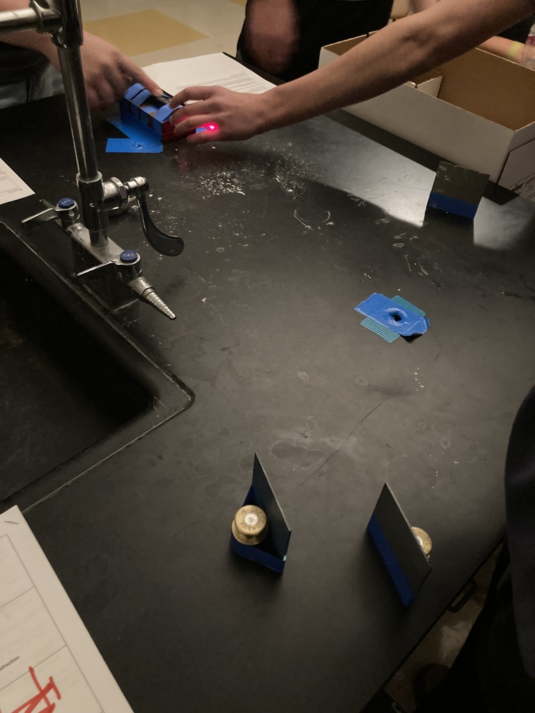 Students setting up a laser light