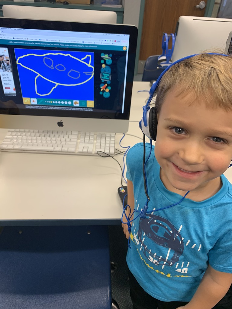 Kindergarten students are practicing mouse skills and creating digital art.