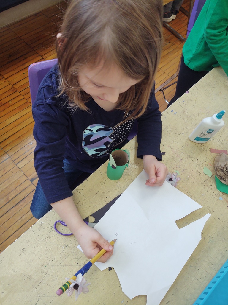 1st graders making paper puppets in art