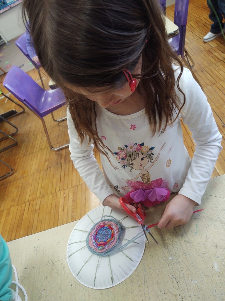 2nd graders creating circular weavings in art 