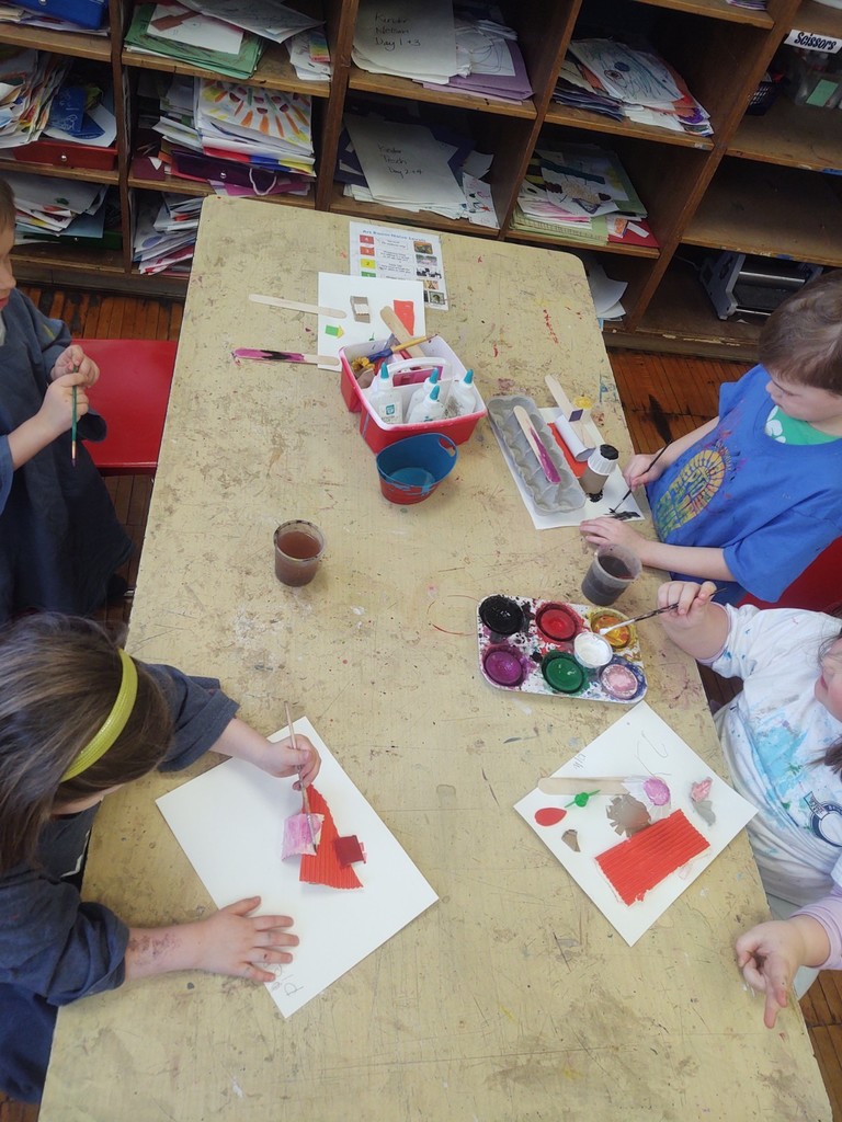 Kindergarten artists painting their recycling sculptures.