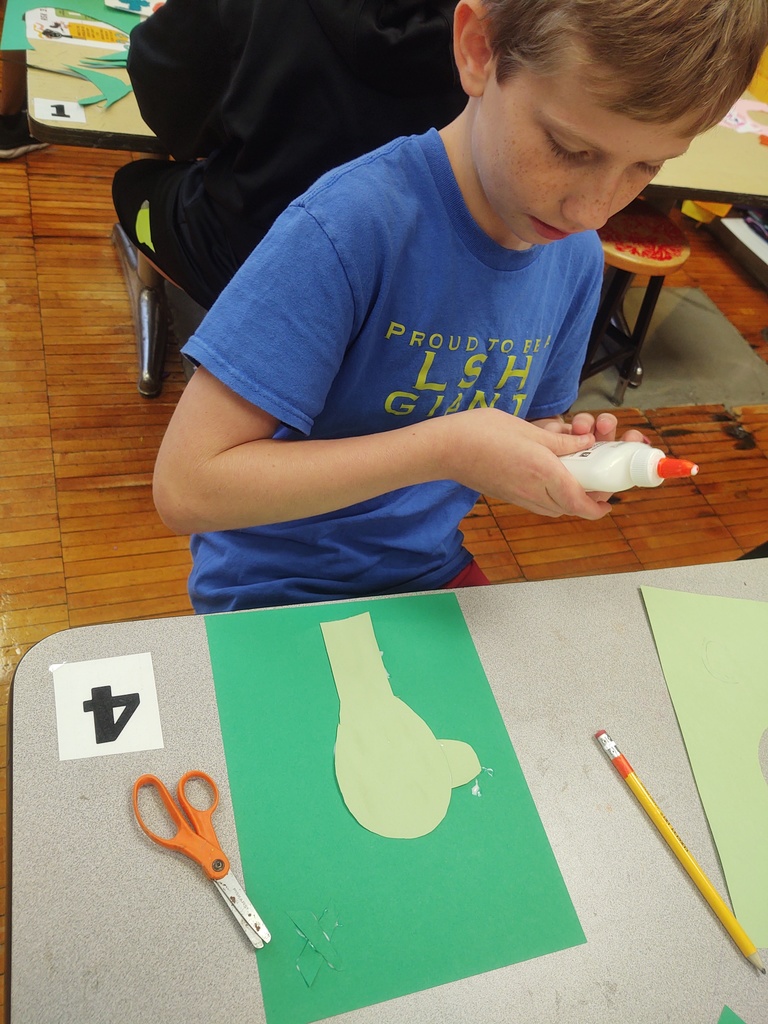 5th graders working on joyful monochromatic collage self portraits. Students are exploring ways to express an emotion with color.