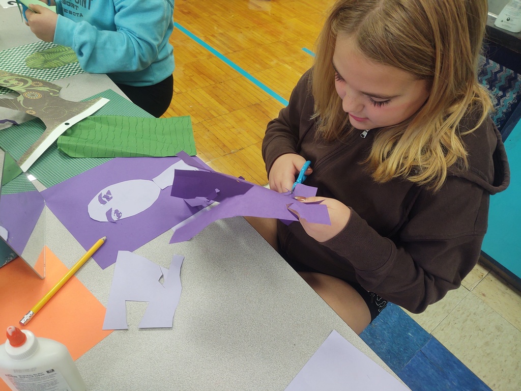 5th graders working on joyful monochromatic collage self portraits. Students are exploring ways to express an emotion with color.