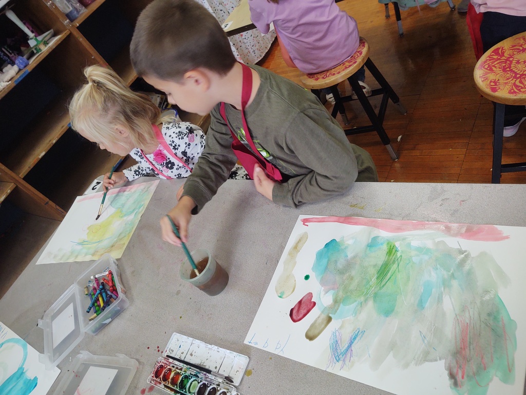 Kindergarteners explore using crayon resist and watercolor paint today in art