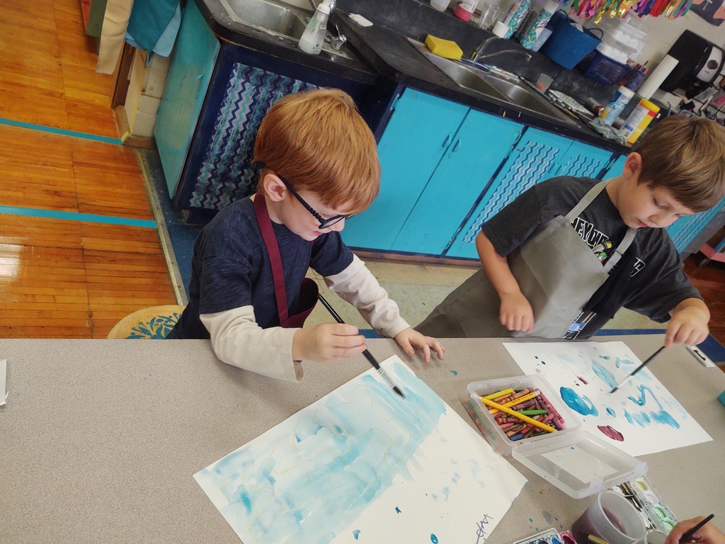 Kindergarteners explore using crayon resist and watercolor paint today in art